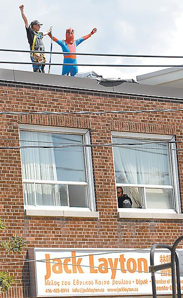 Plywood Man (Mark Bogan) and Spider Man on roof of Jack Layton