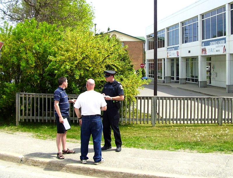 Policeman R Norman speaks to Neil Haskett